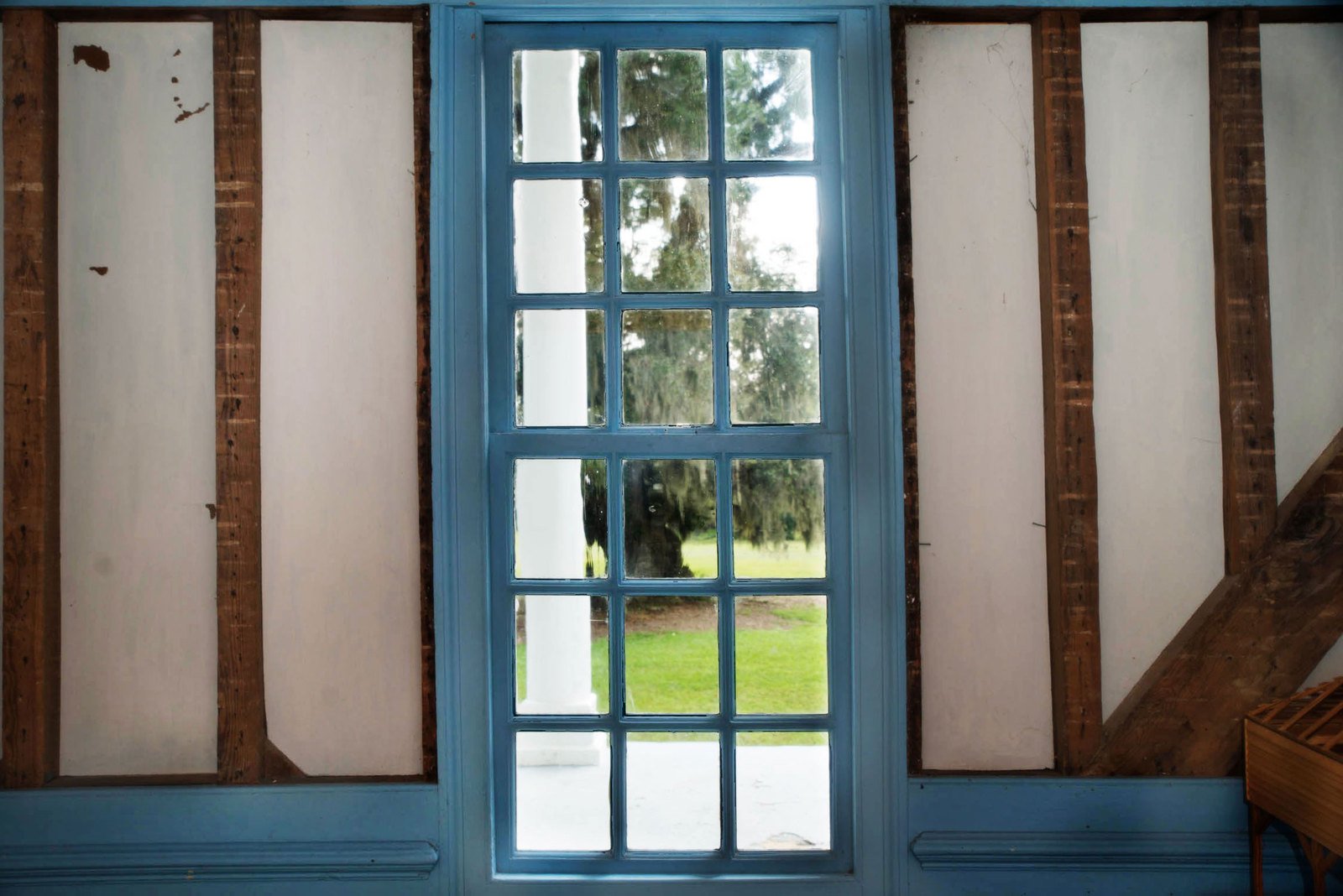 a wooden table sitting in front of an open window