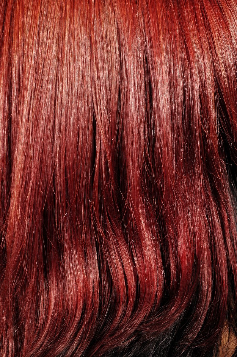 a closeup of a red - dyed hair with reddish tones
