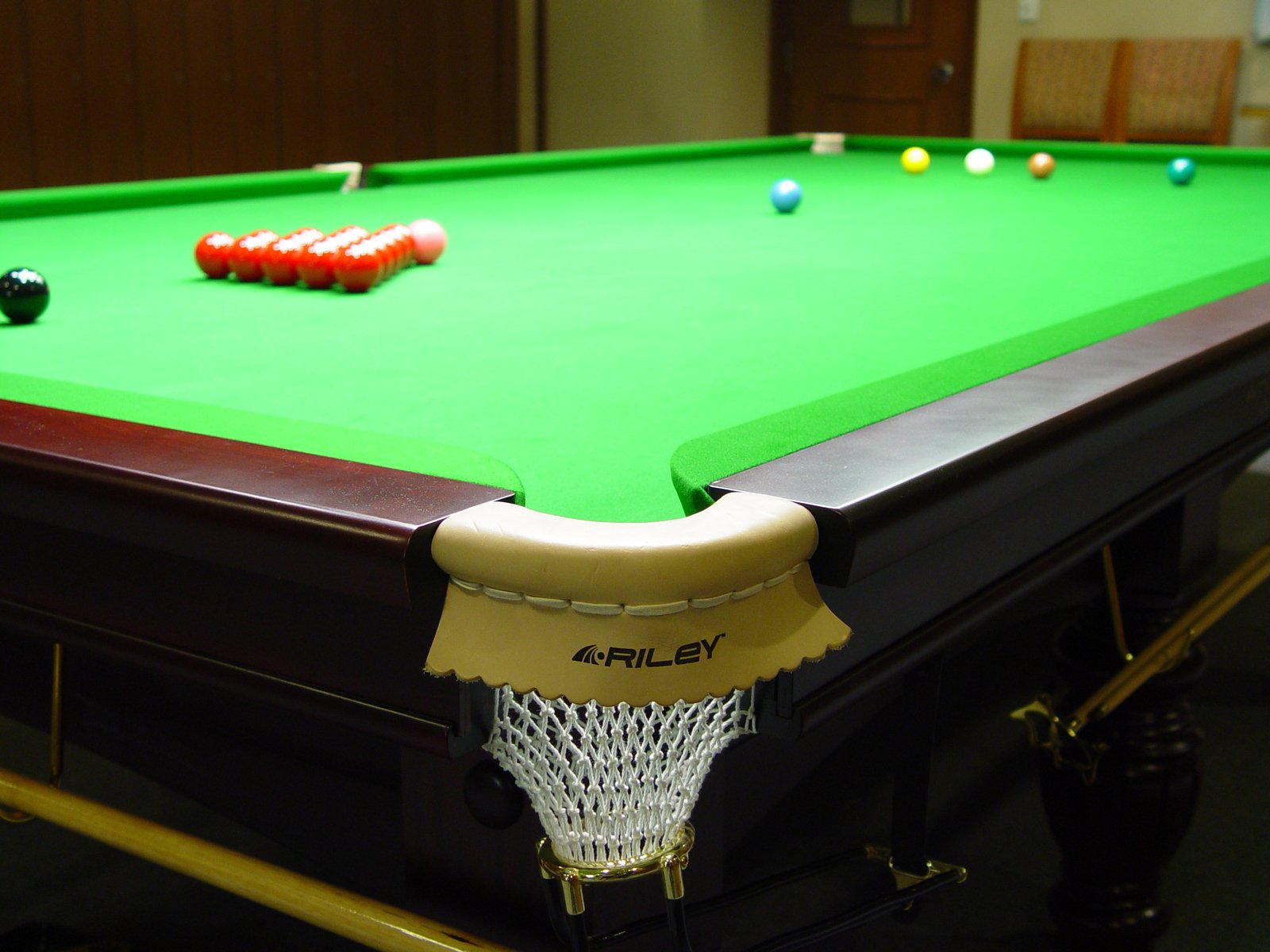 a pool table in a gym with two billards and balls