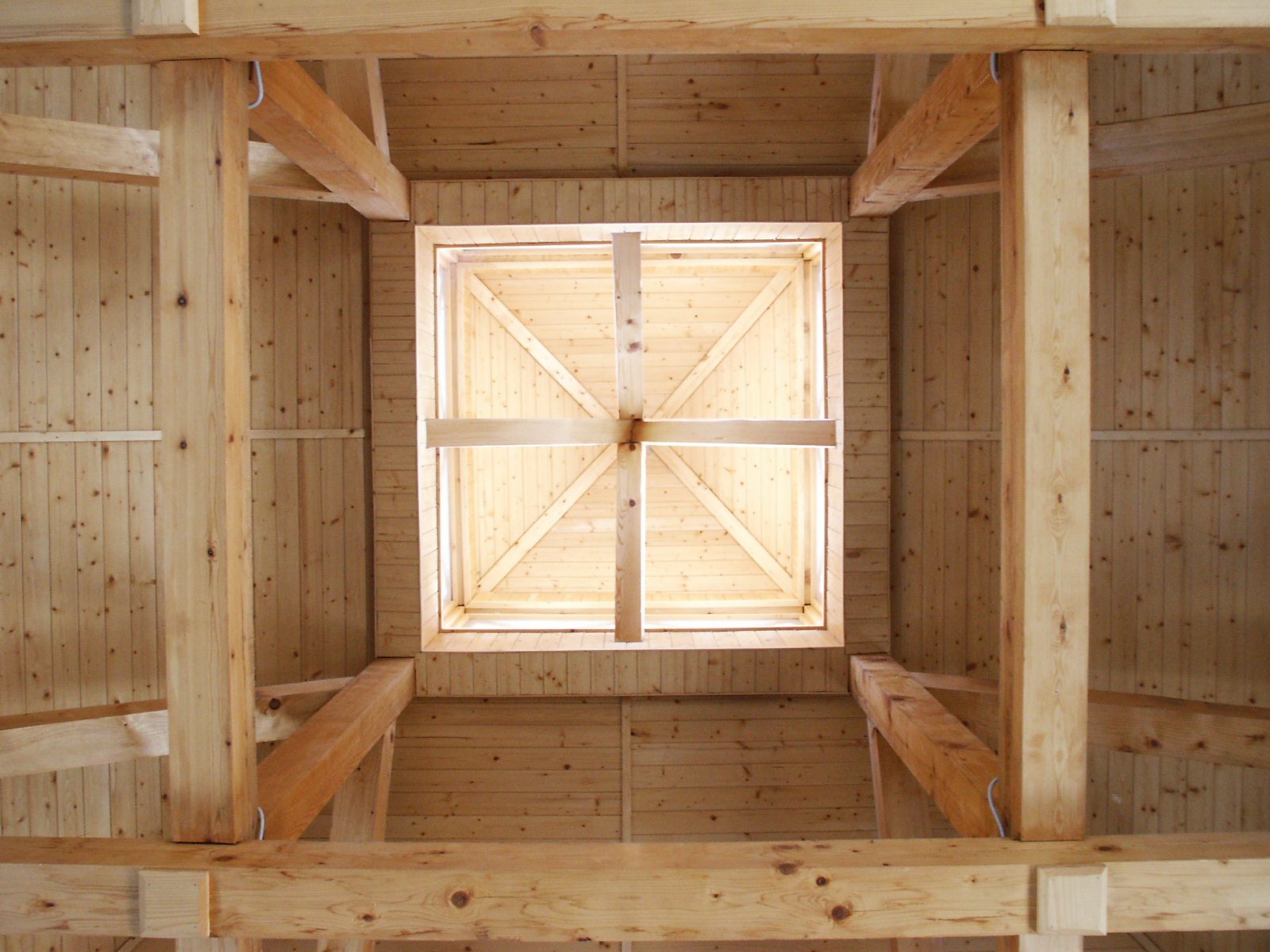 an empty wooden room with no roof and windows