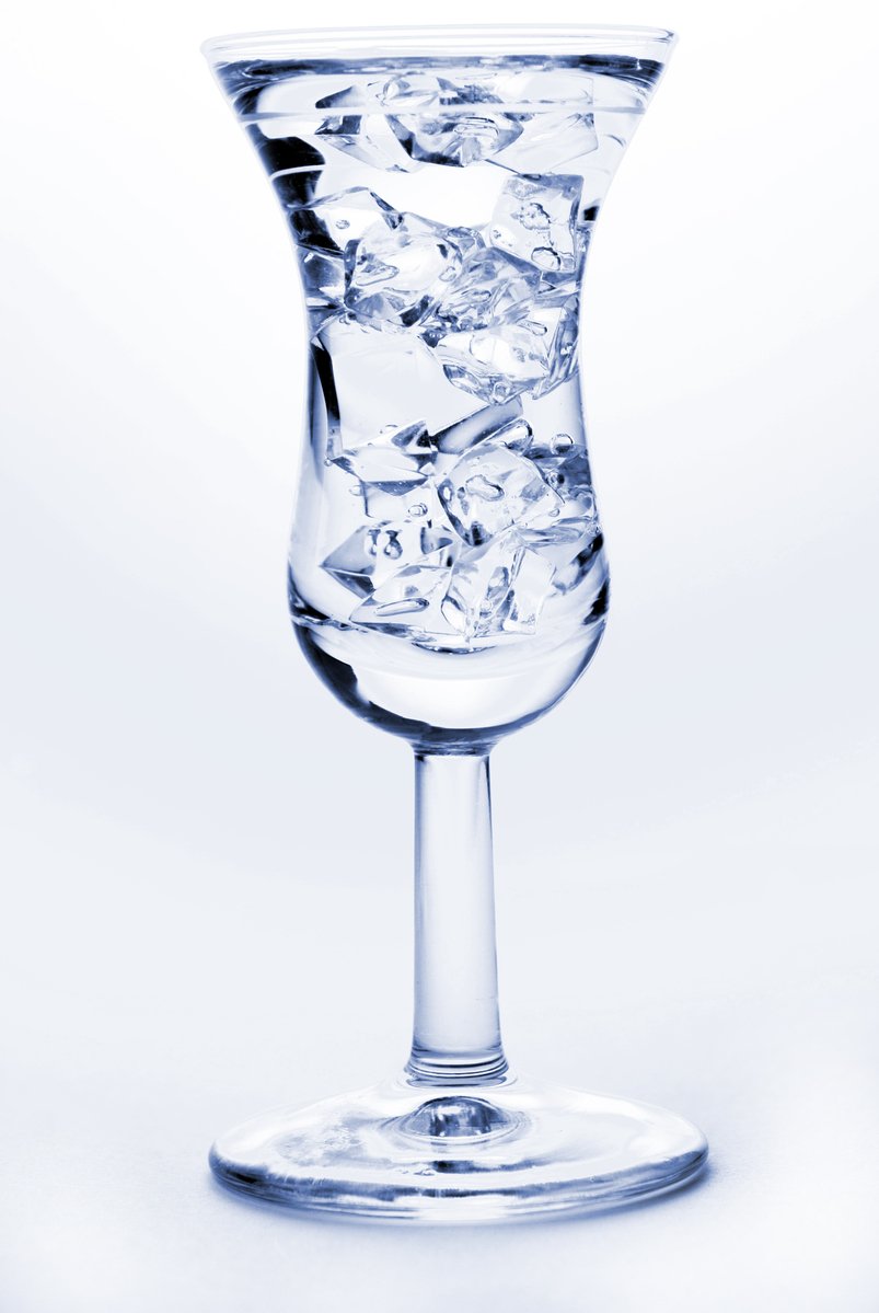 an empty wine glass on white background with water splashing