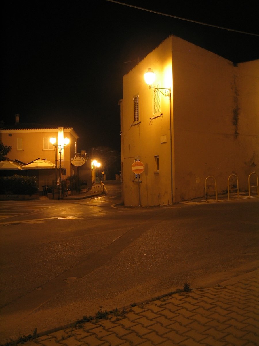an exterior area with a gate, lights and a wall