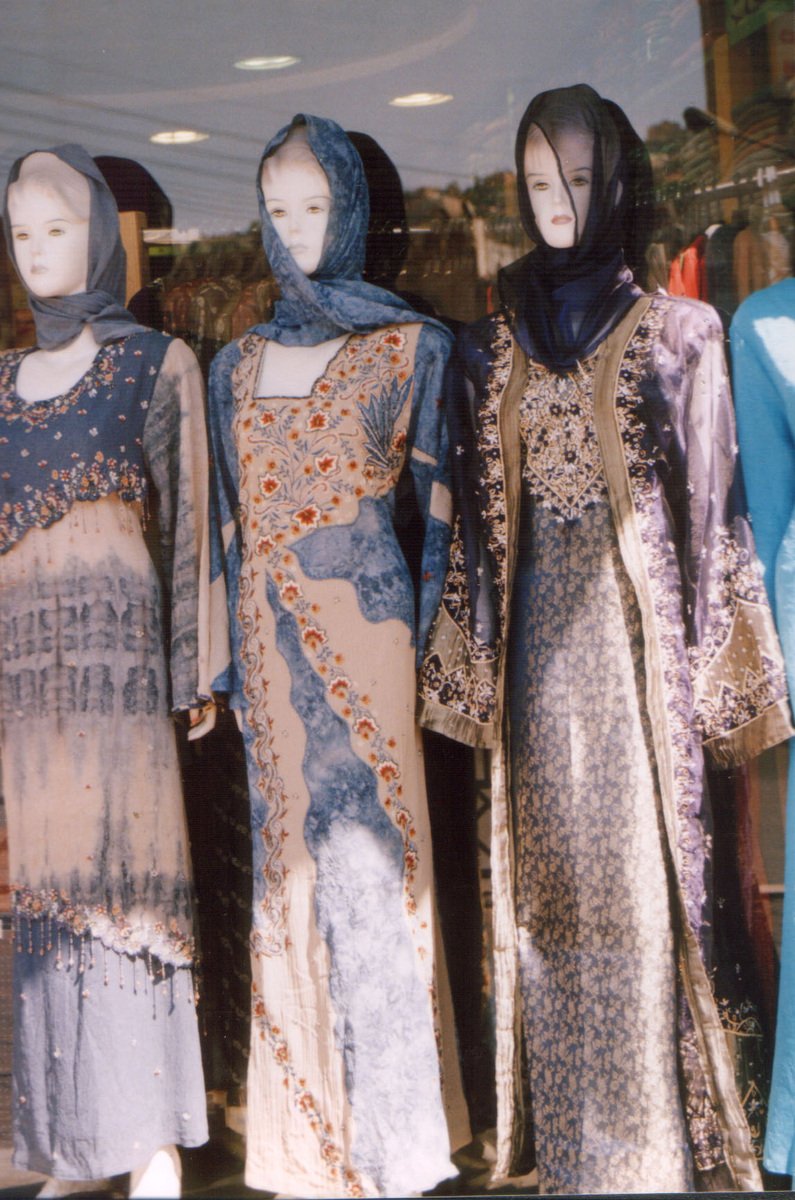 three mannequins are lined up wearing muslim clothing