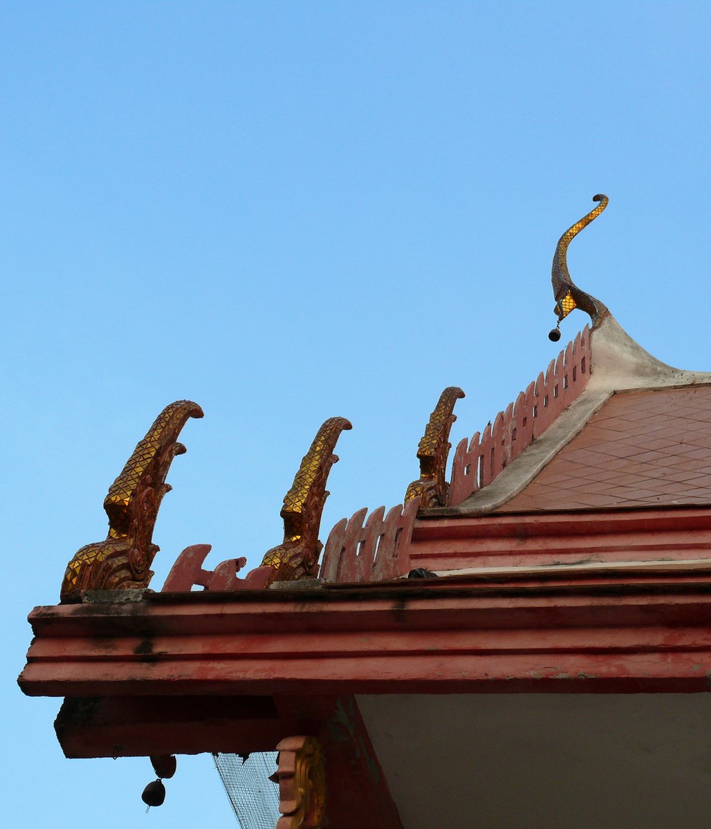a roof with gold bird sculptures on it