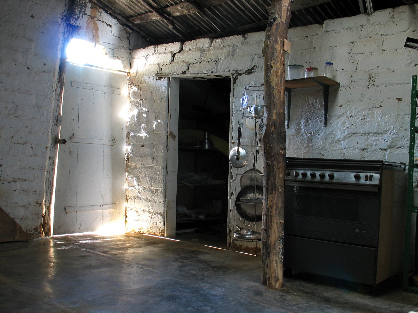 an open door on the wall to an oven in a room