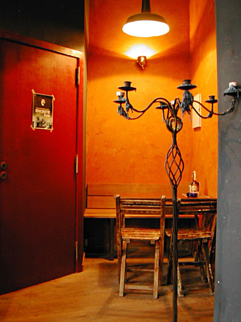 an open door and dining room lights in the corner