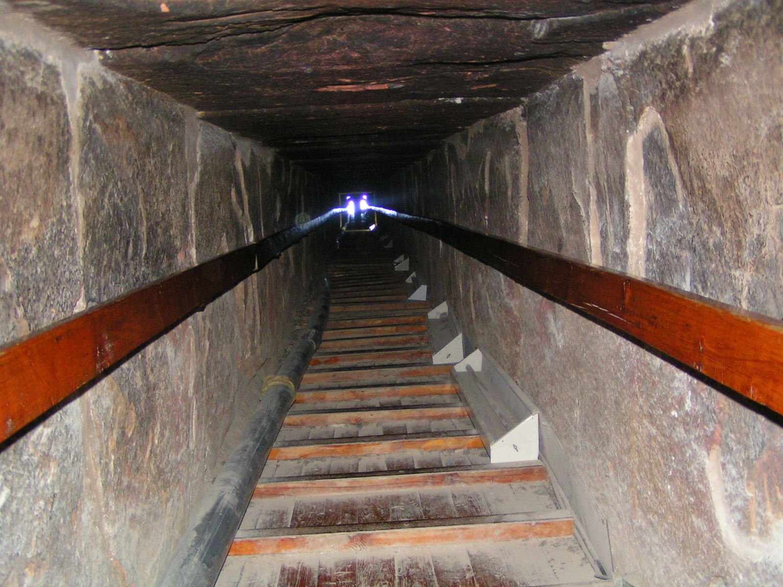 a long, narrow staircase leads to a well preserved tunnel