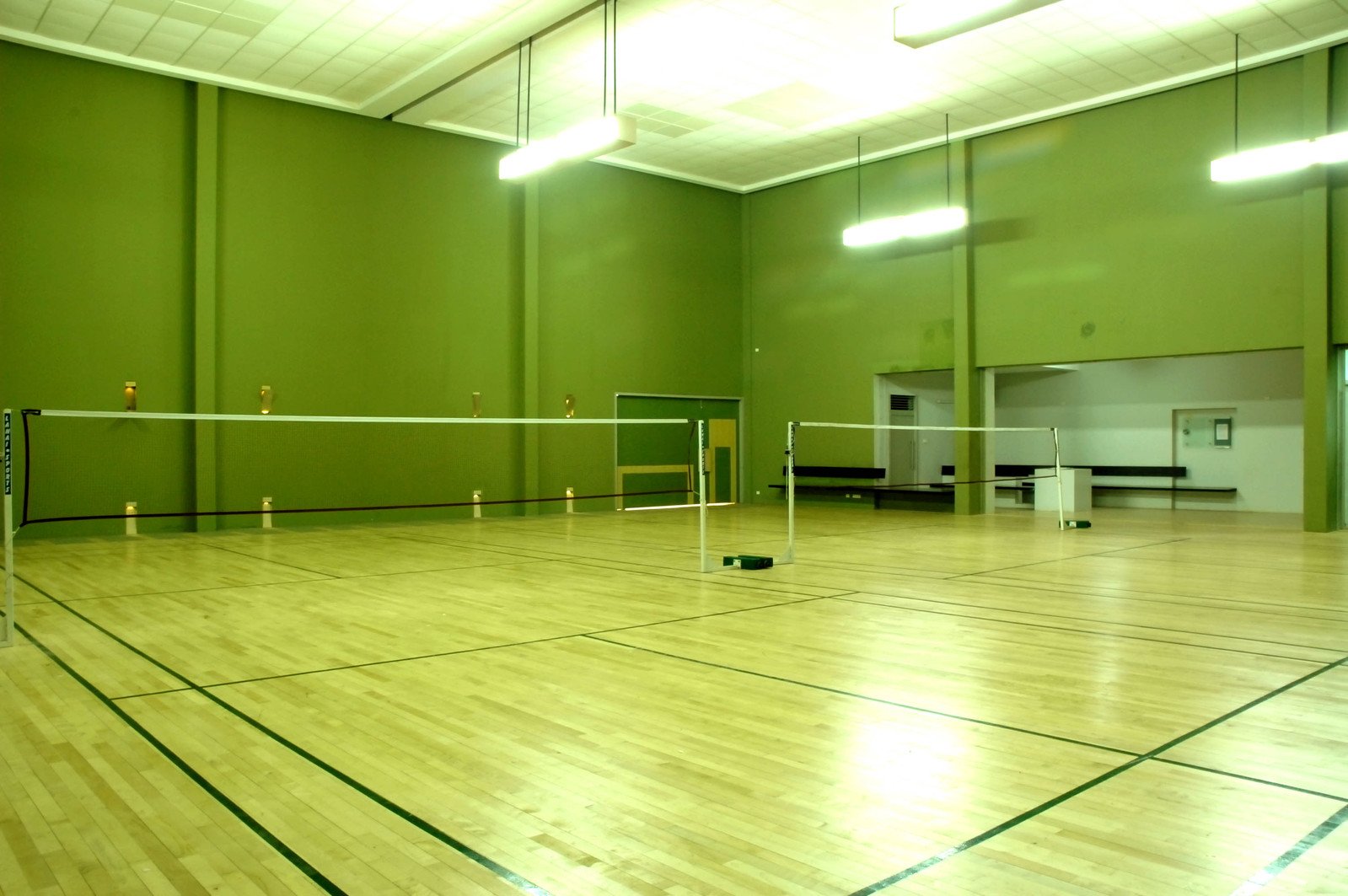 large empty indoor sports court with wooden floor