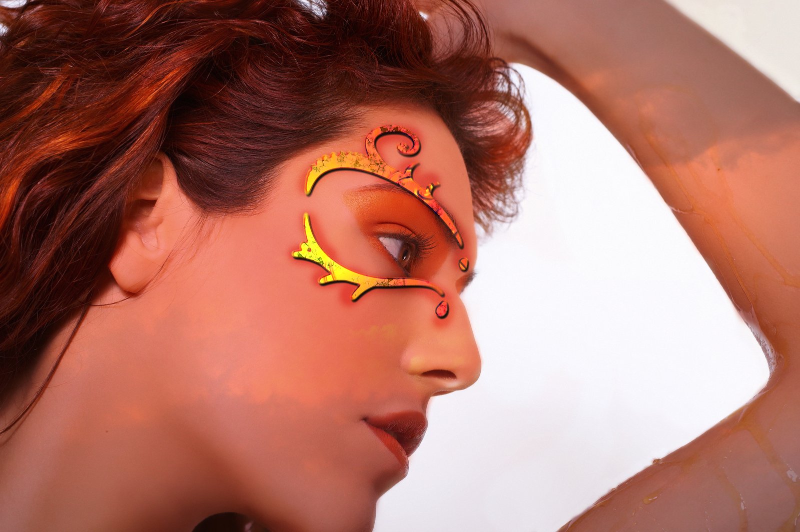 a woman with orange makeup and bright face paint
