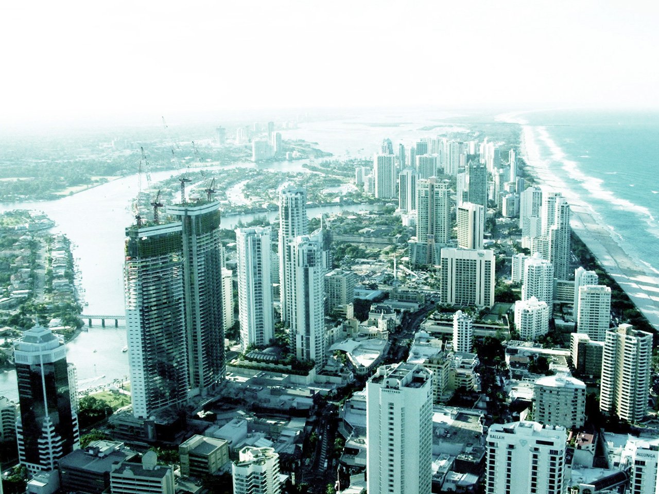 cityscape is shown next to the ocean and water