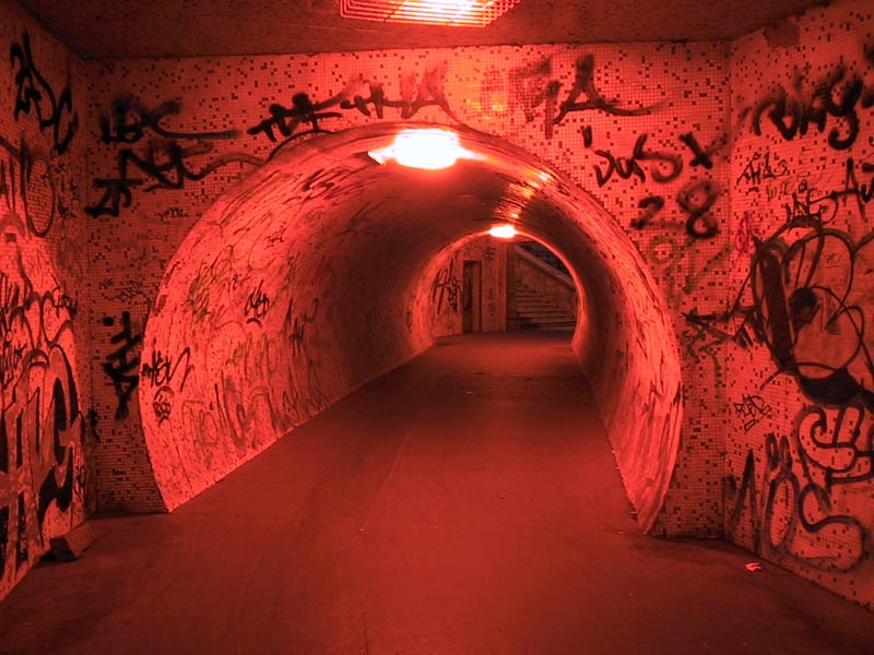 a long tunnel with a bright red light
