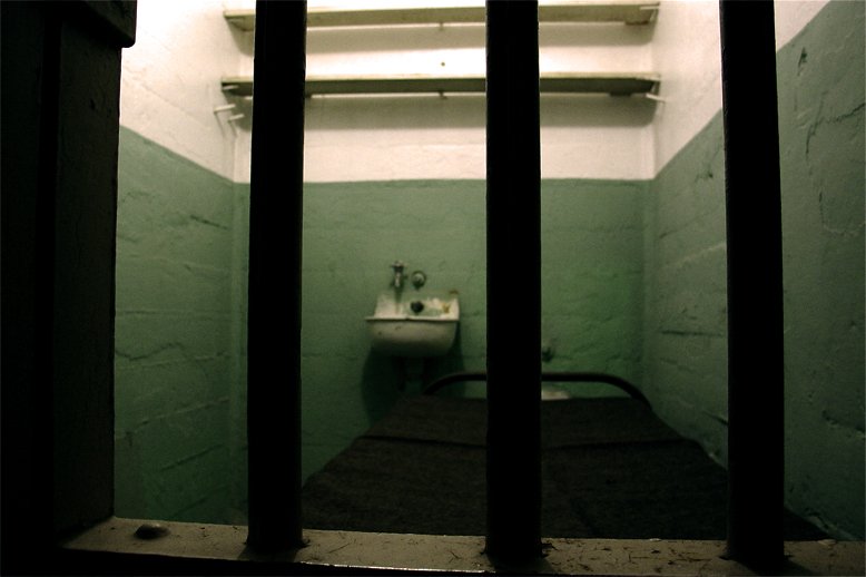 a  cell with a sink and a toilet