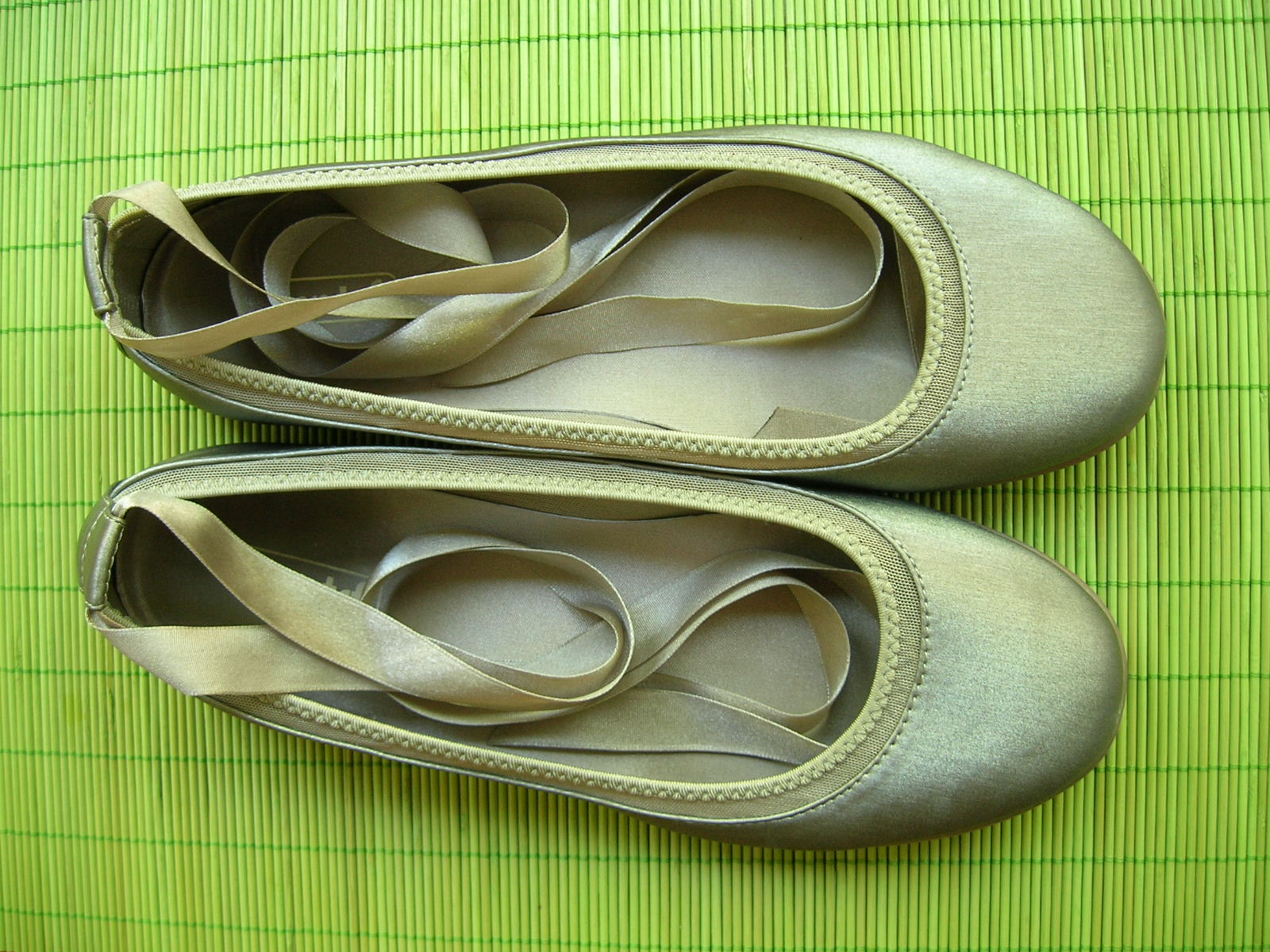 pair of beige shoes on a green placemat