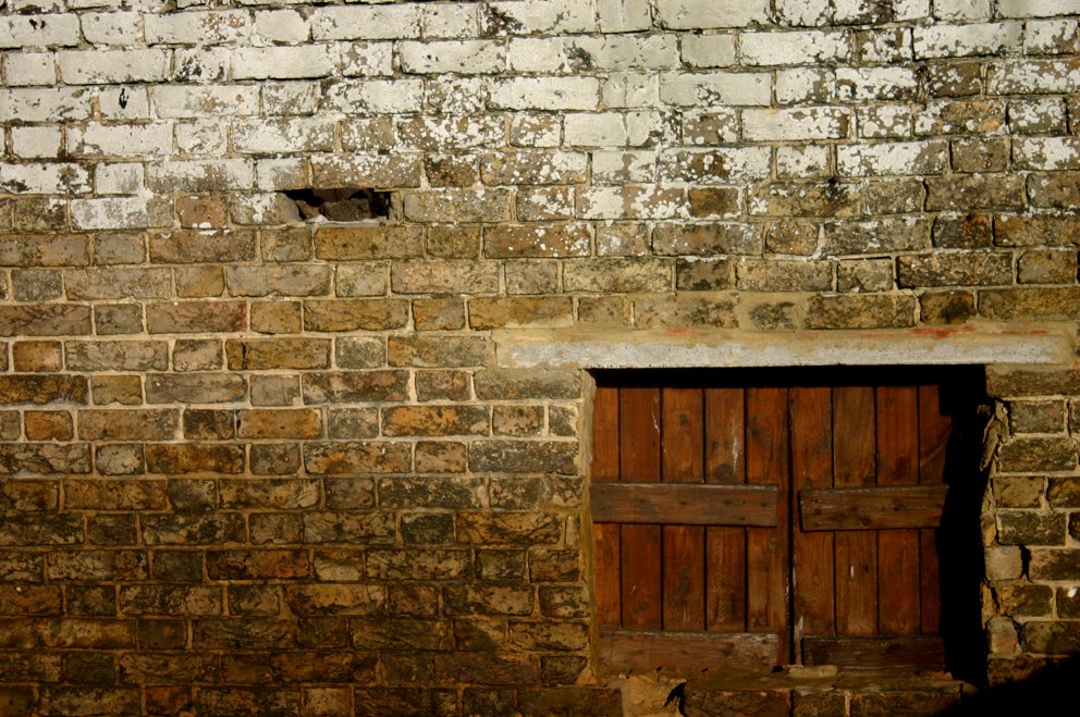 old doorway and window made out of brick and wooden