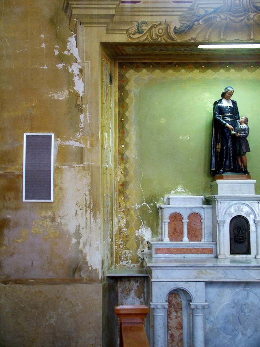 the statue stands on top of a marble fireplace