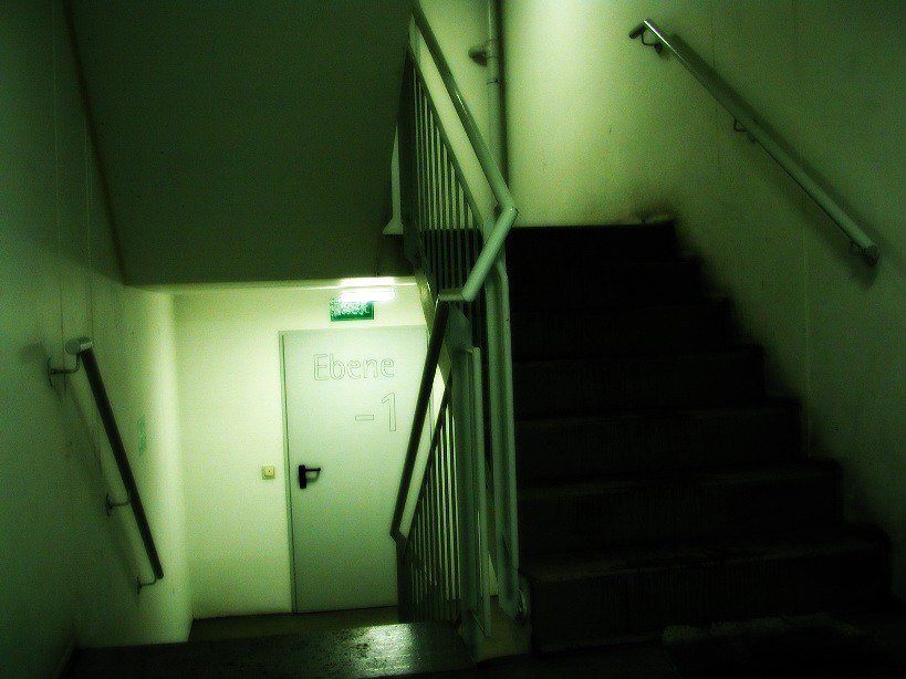 a staircase with some white walls and a sign that reads leave