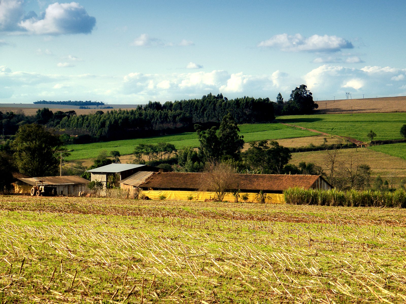 there is an old farm with hay and houses