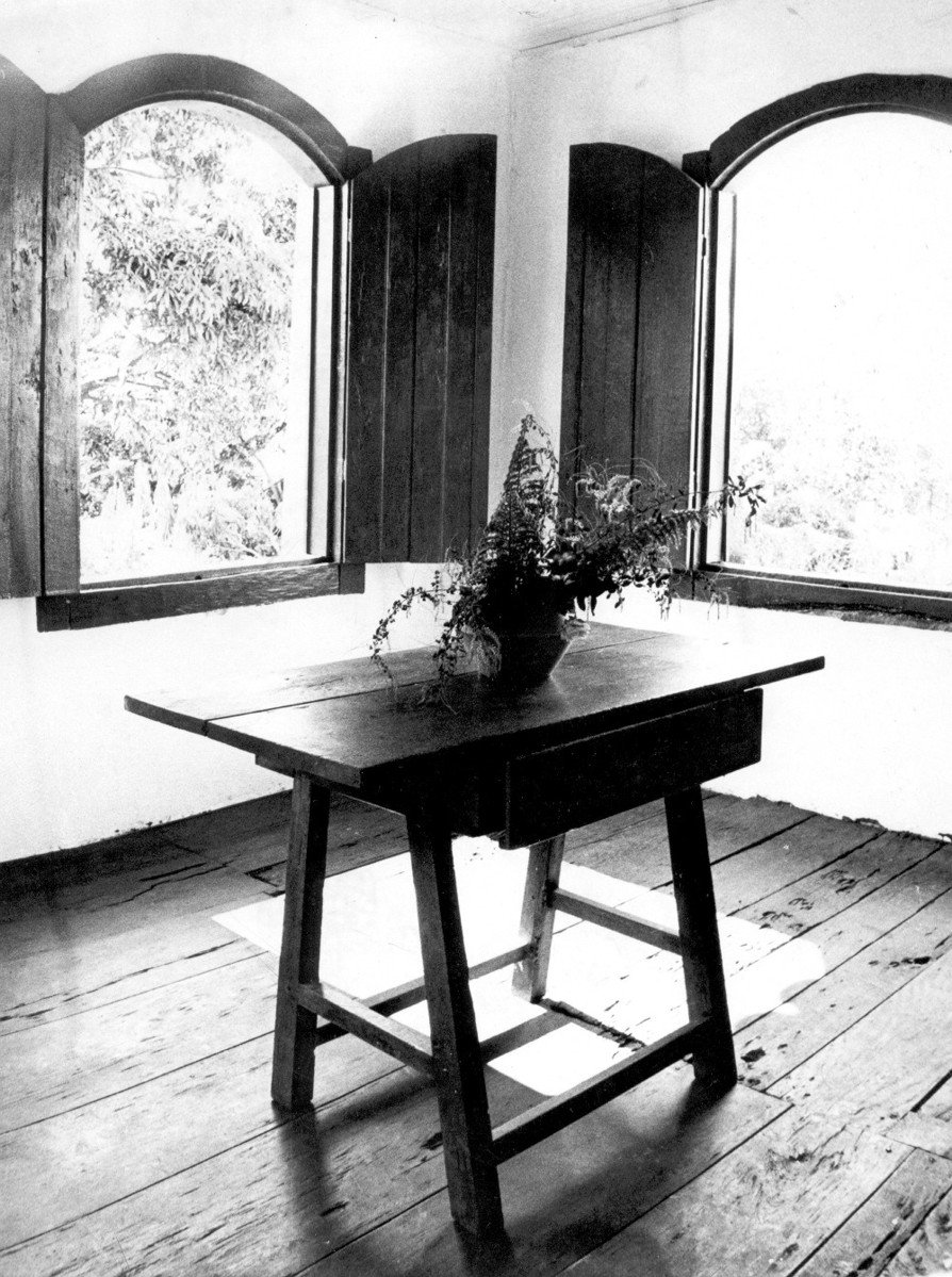 black and white image of room with large windows