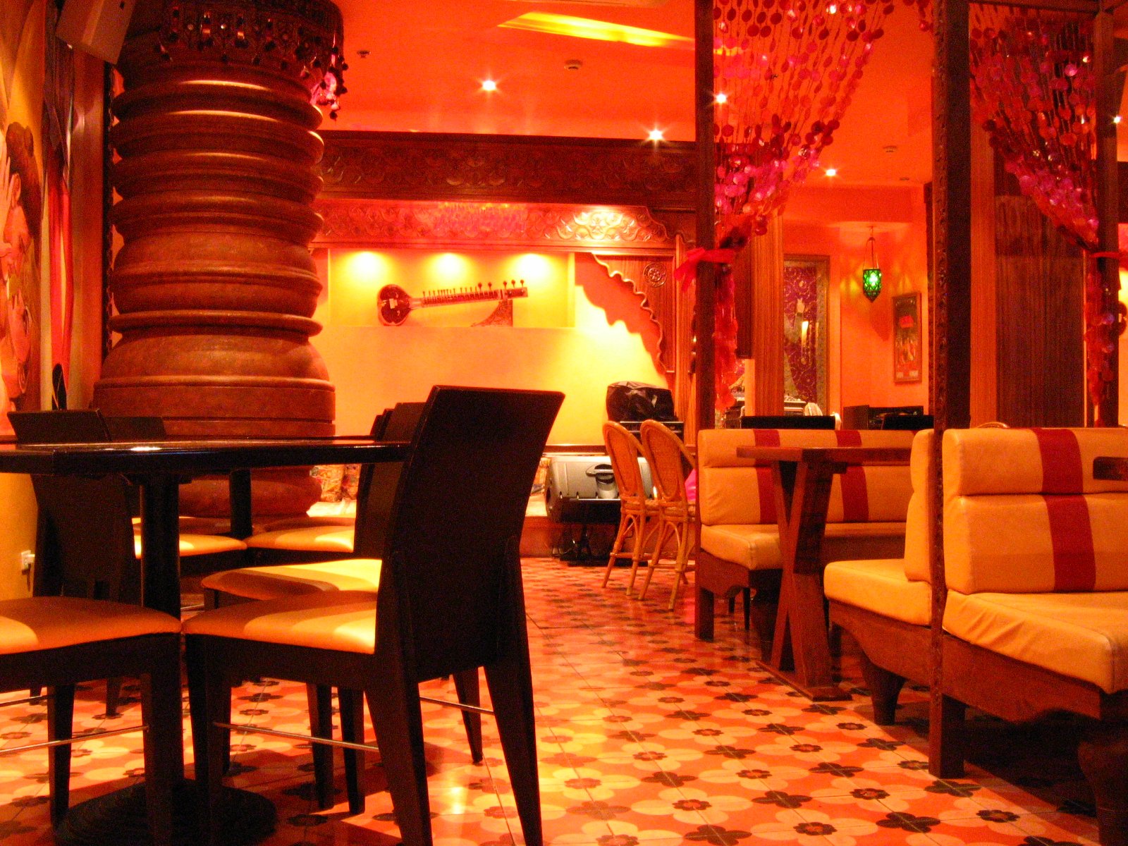 the interior of a fancy restaurant with table, chairs and decor