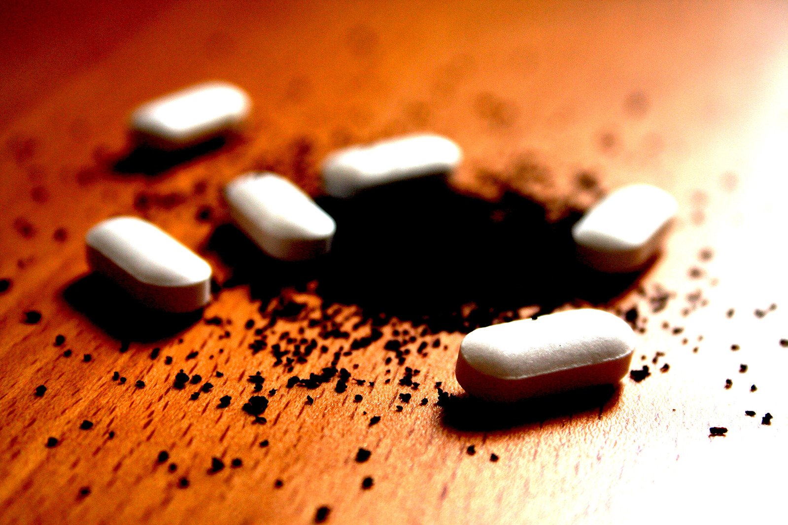 six white marshmallows are scattered around an open wooden table