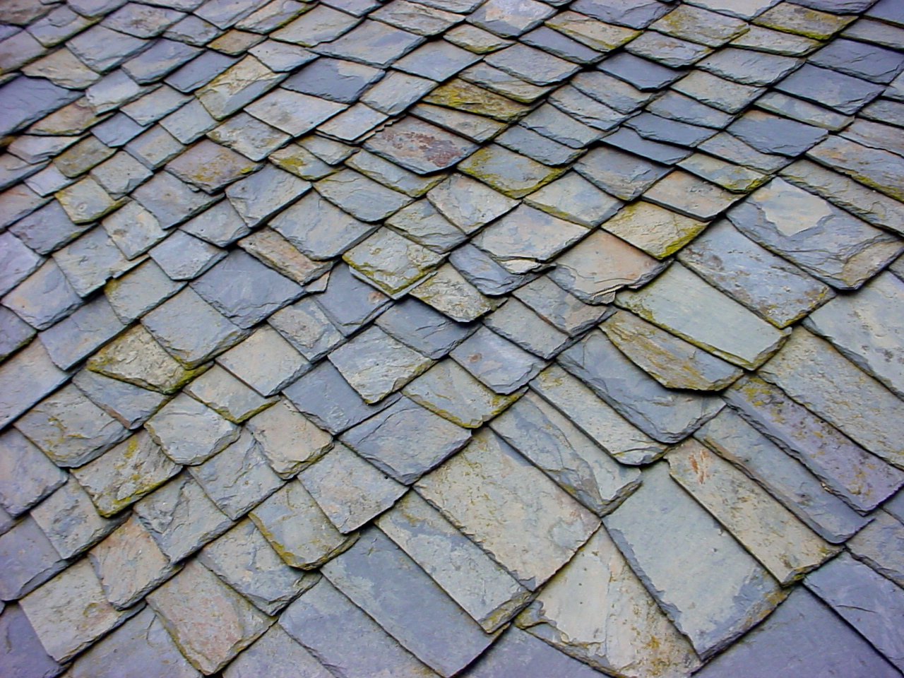 a brick roof with slate stones laying across it
