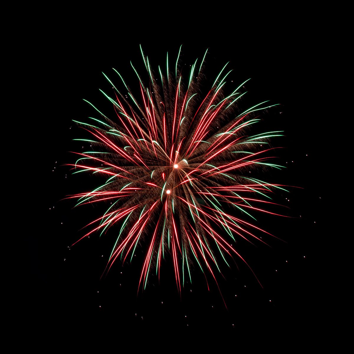 a firework with lots of colorful lights in the dark