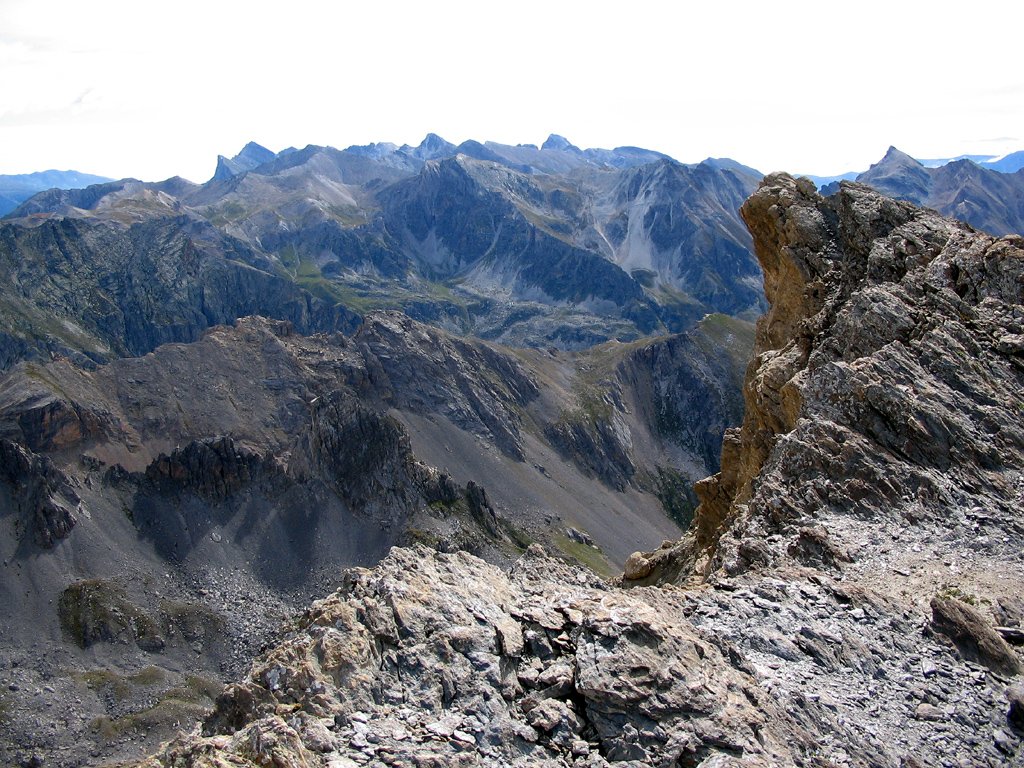 a rocky ridge with mountains in the background