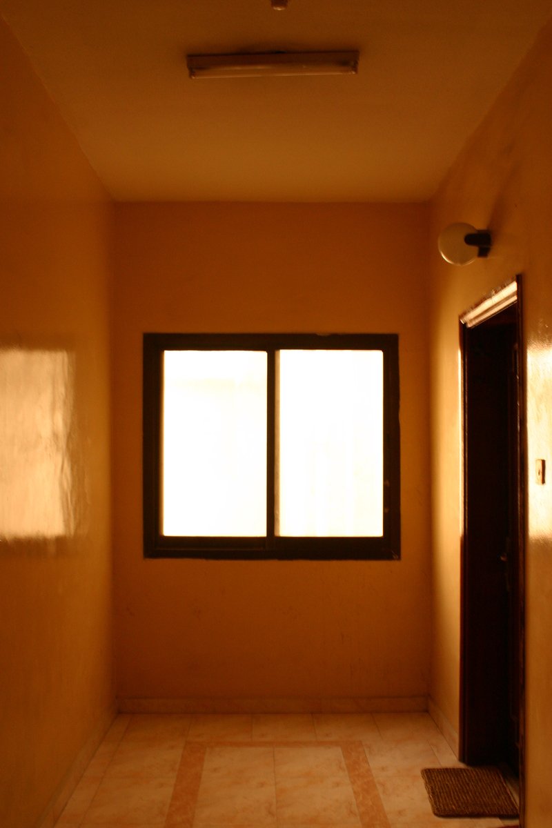 an empty room has a window with three windows