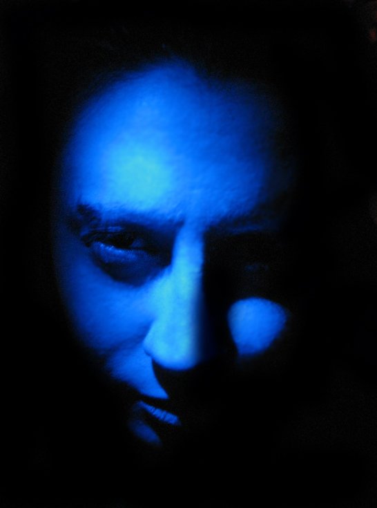 a man is projected in blue light on the computer screen