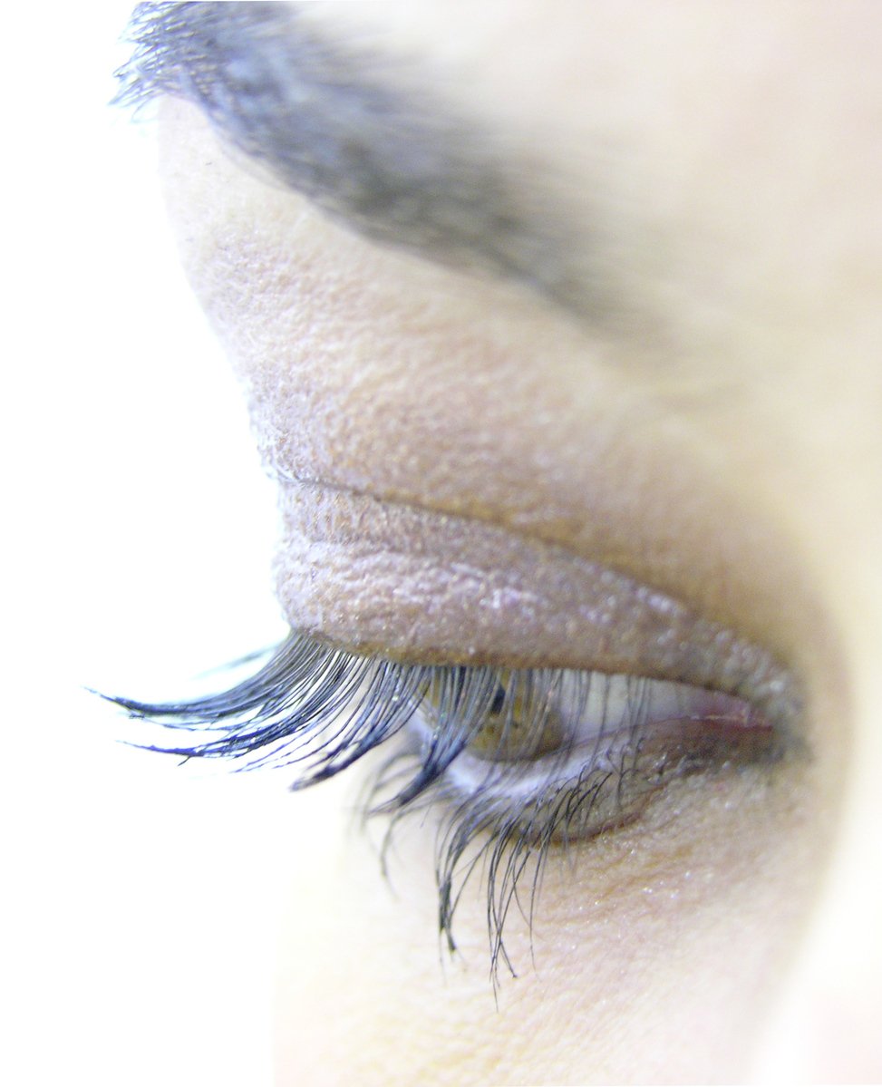 a close up of a persons eye with long eyelashes