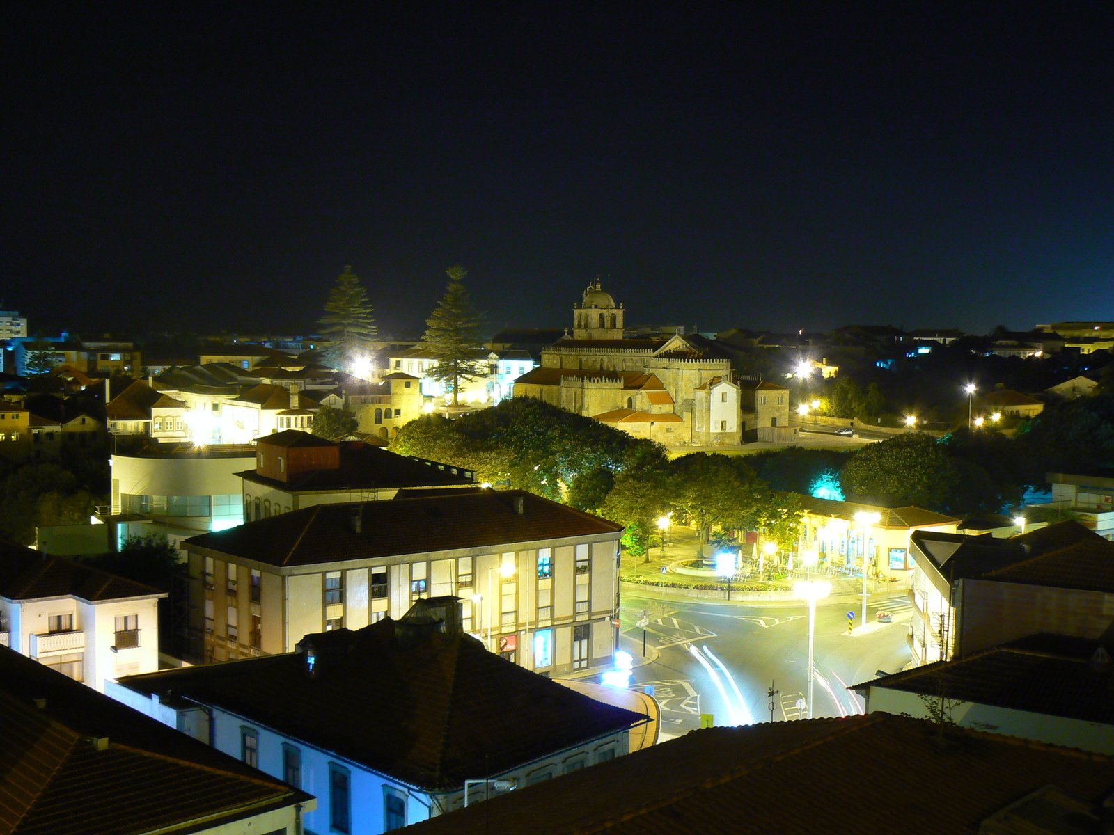 a night time city view shows a small town and a church