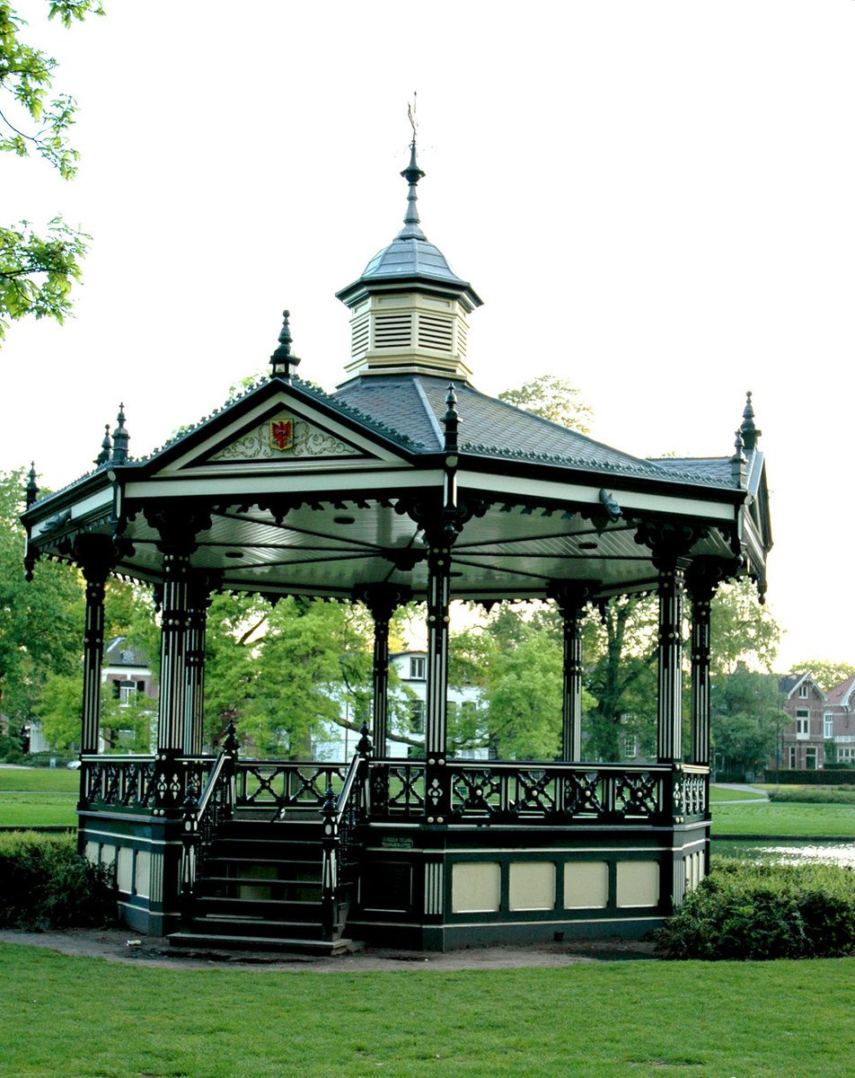 a gazebo in the park with a clock on the top