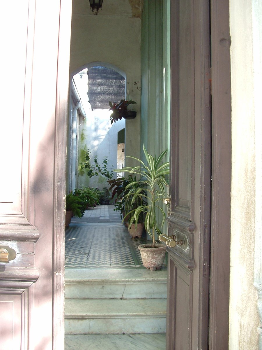 an entry way to an open air building, with a potted plant on one side