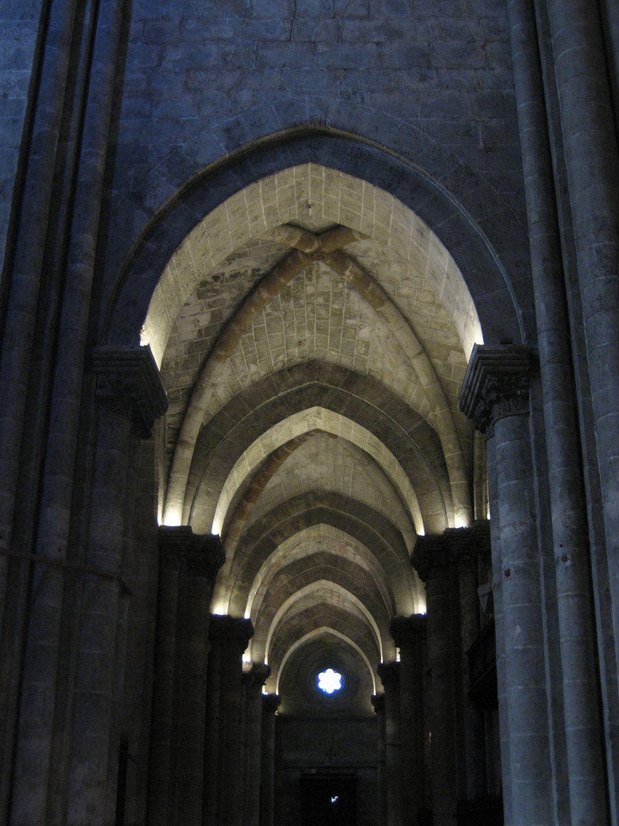 a very long narrow passage with many pillars