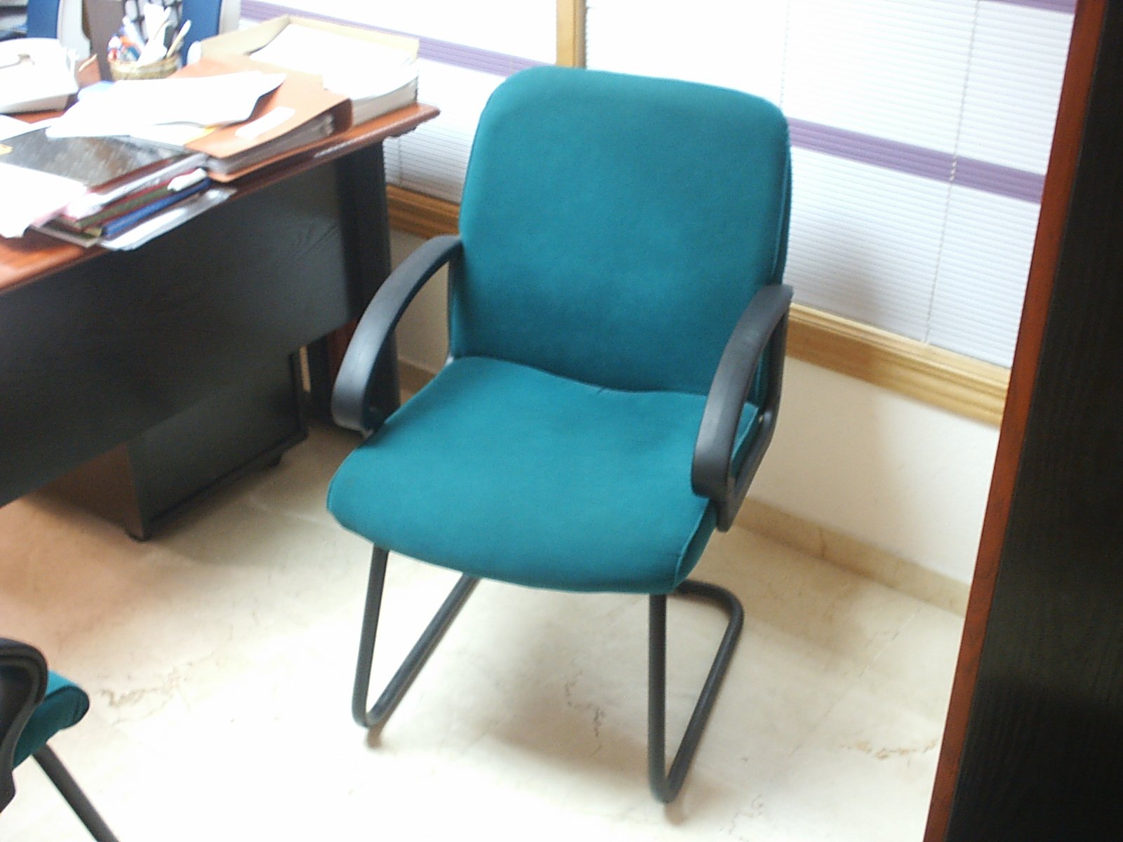 the blue office chair is next to the desk