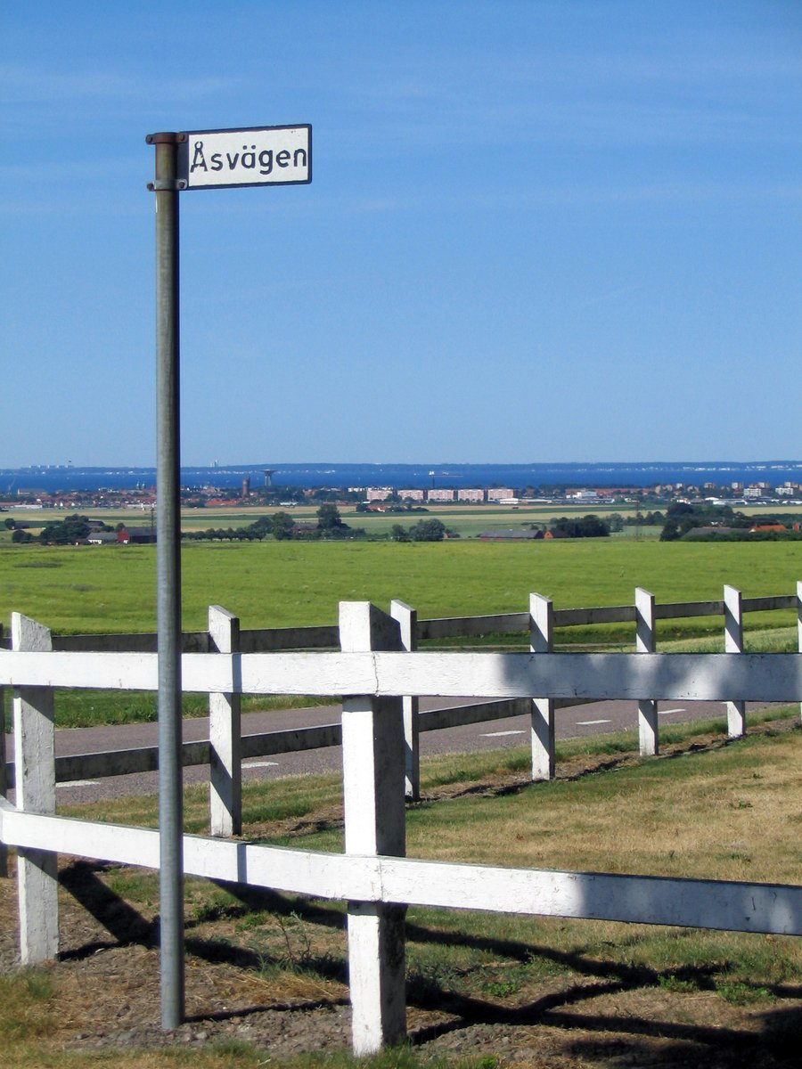 a fenced off field and sign on the side