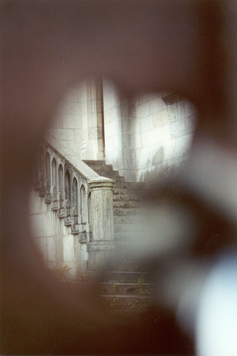 a person standing in the hallway of a building looking at stairs