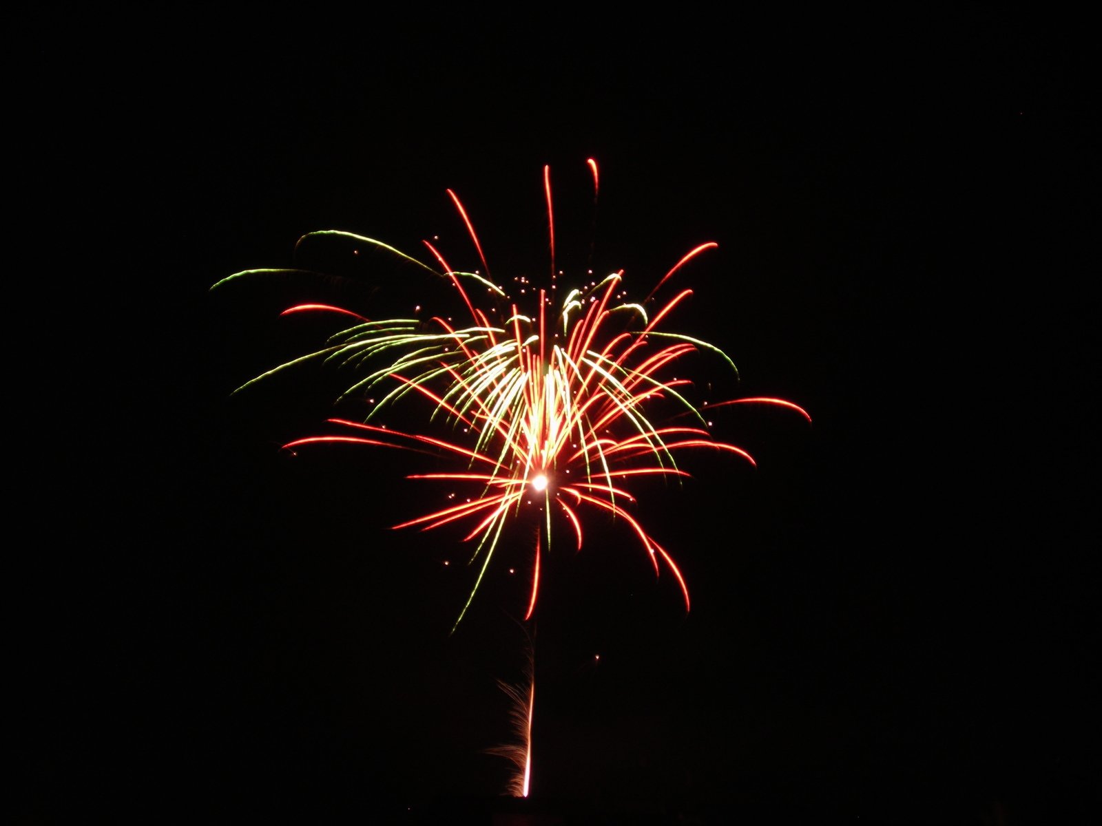 a fireworks in the night sky with dark background