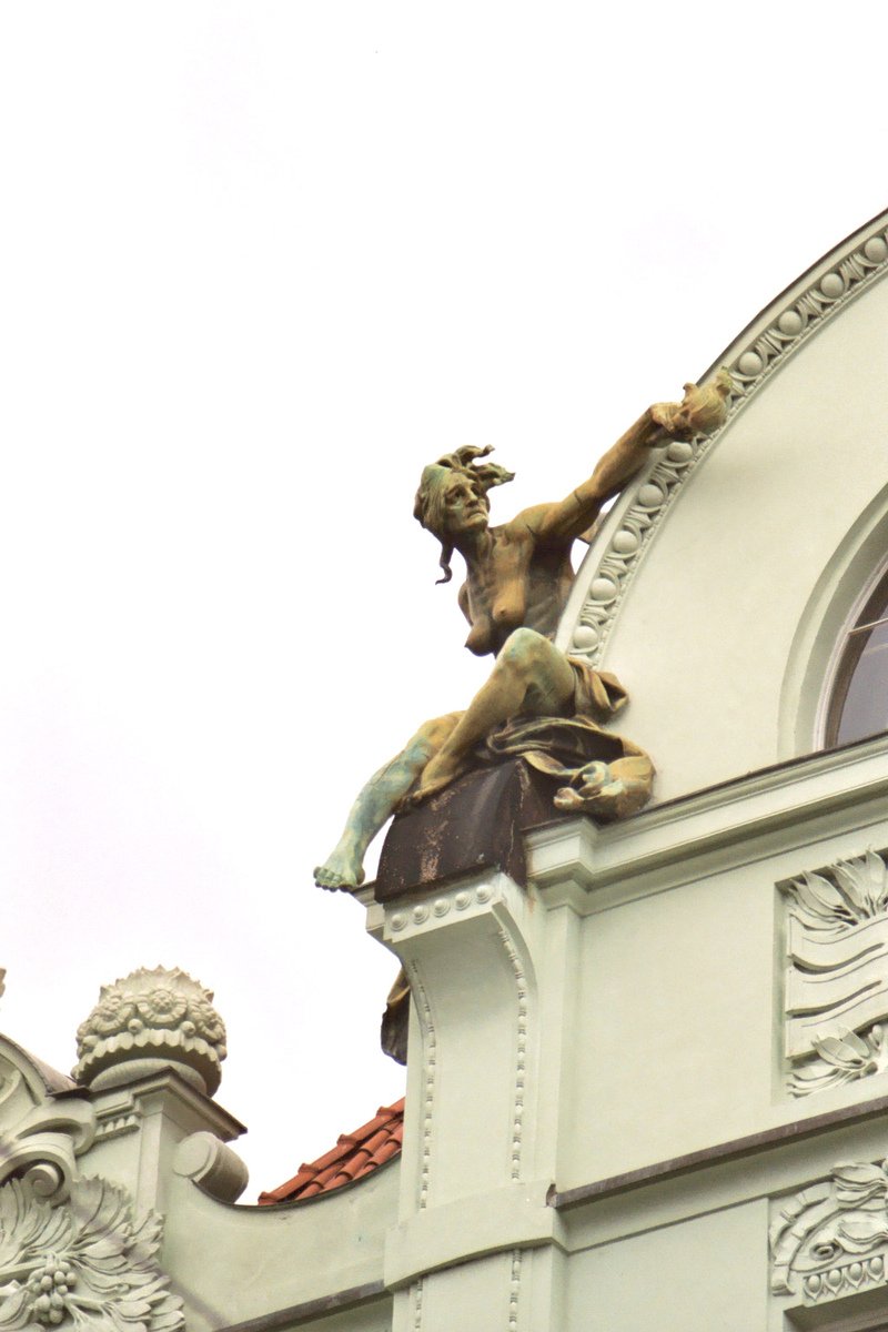 a close up of a statue on top of a building