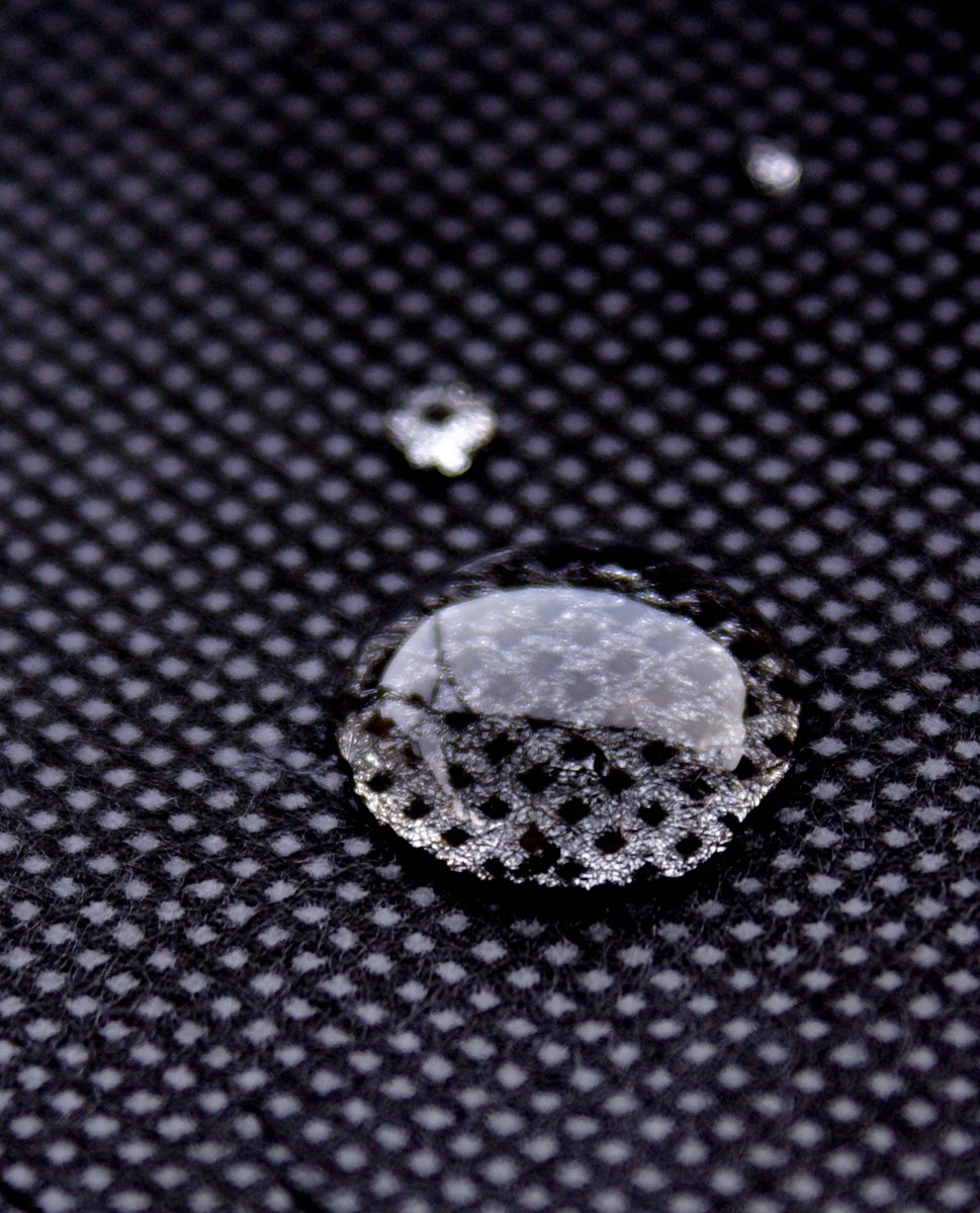 a water droplet sitting on top of a fabric