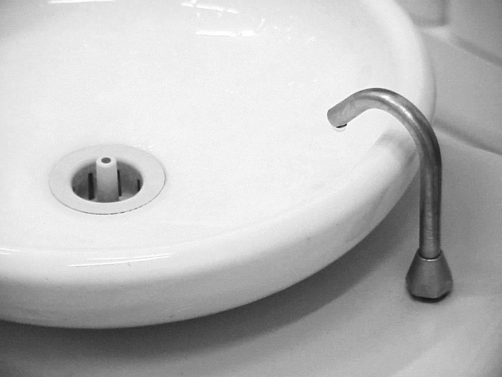 a sink with a metal spout on the right hand side