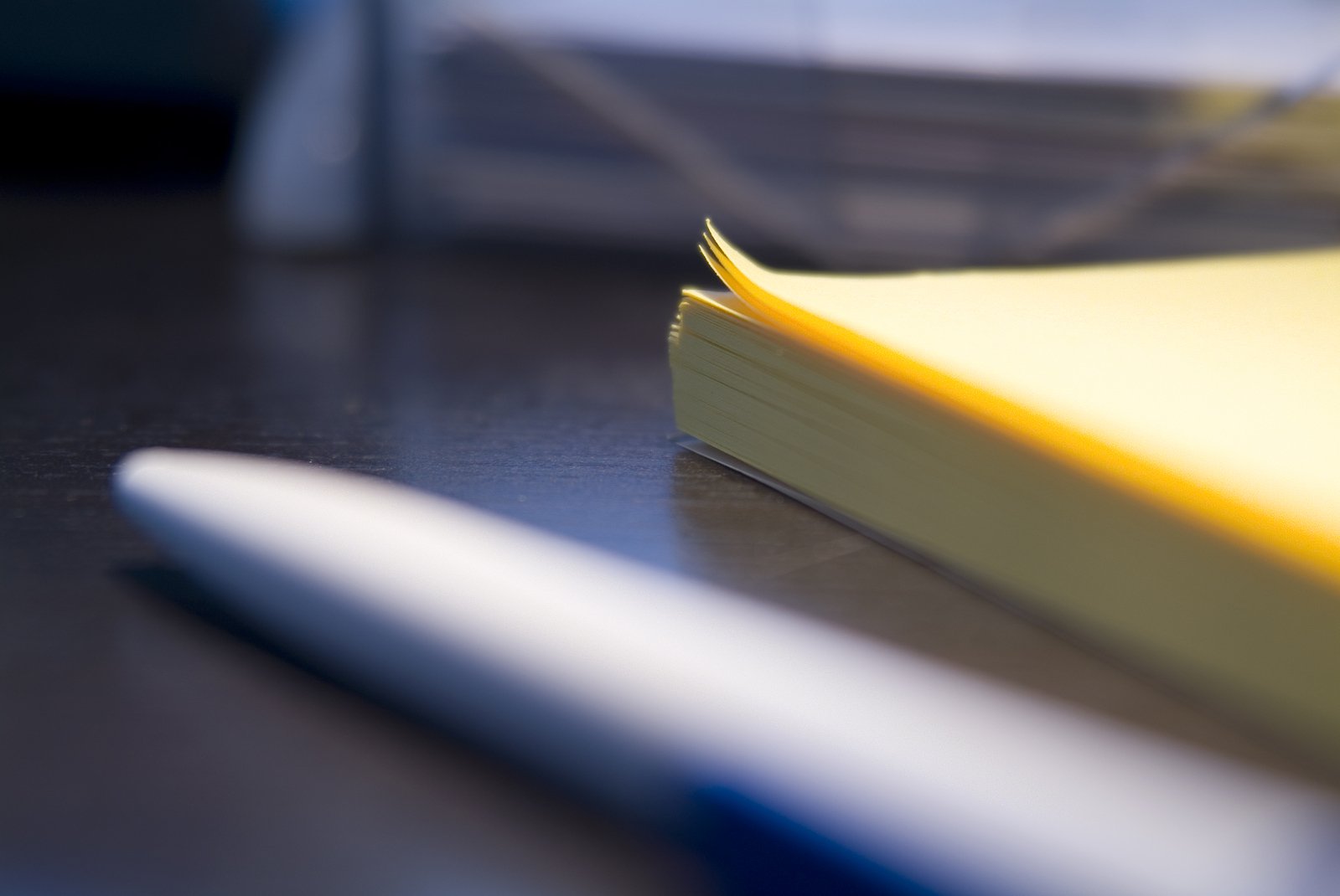 an open book next to a marker on a desk