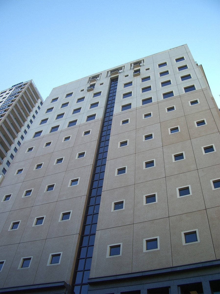 view up to a building with many windows and windows