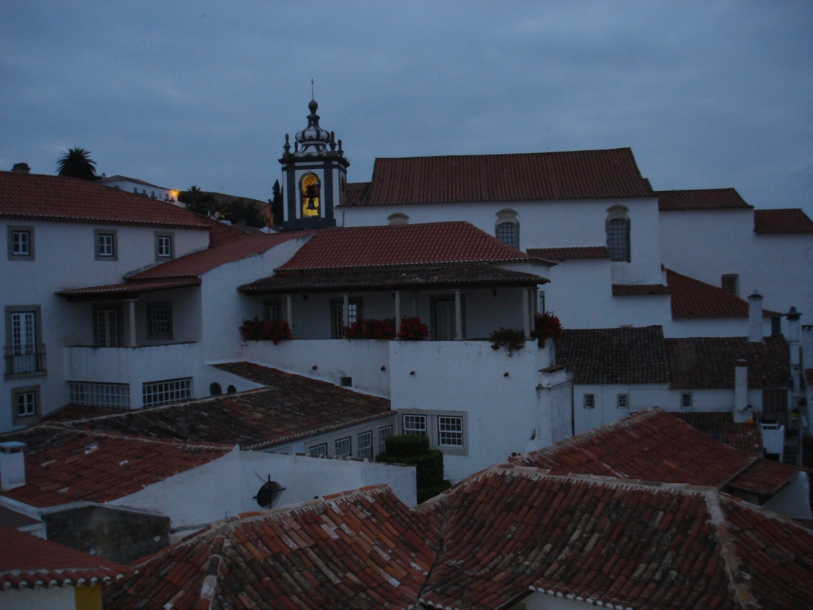 a full view of a building with a clock at the top