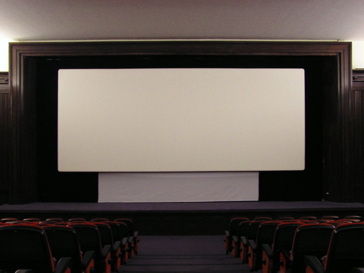 an empty screen sitting in a theater