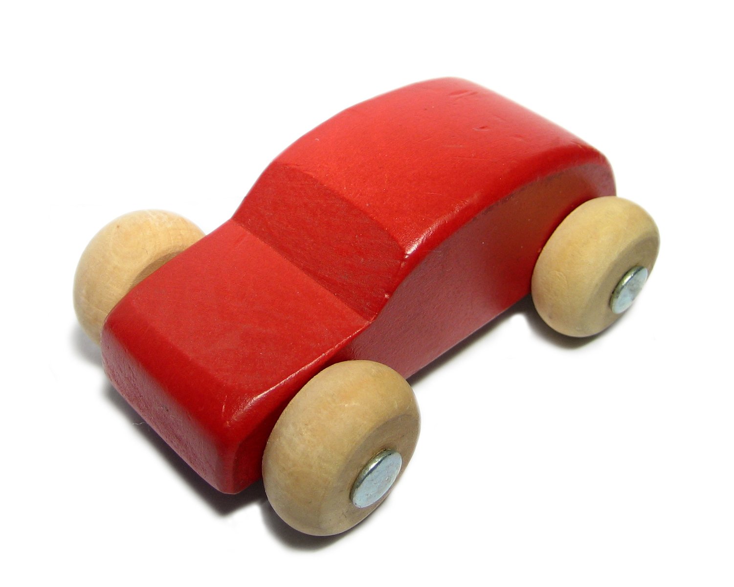 a red wooden toy car sitting on a white surface