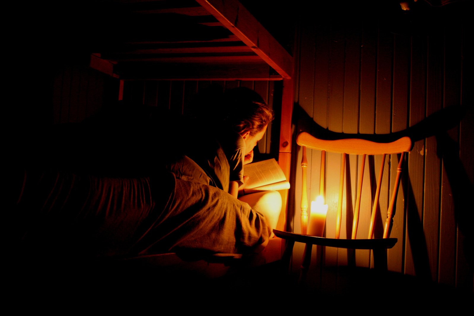 a woman reading a book with a light