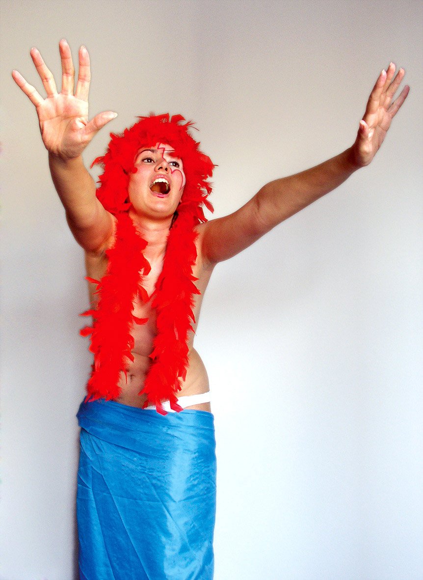 a man dressed in a blue skirt and red furry boa