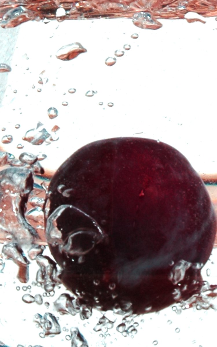 a plum in some water that is floating