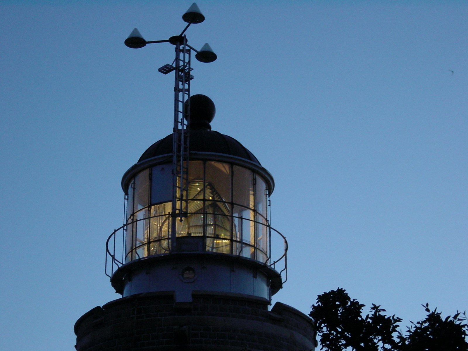 the view of a lighthouse from below, at dusk